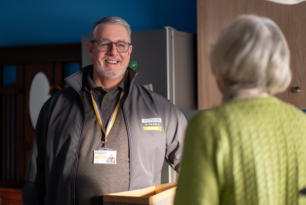 A Wiltshire Farm Foods delivery driver delivering meals to a customer