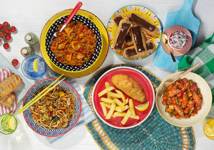 A selection of frozen meals including fish and chips, paella and peach melba